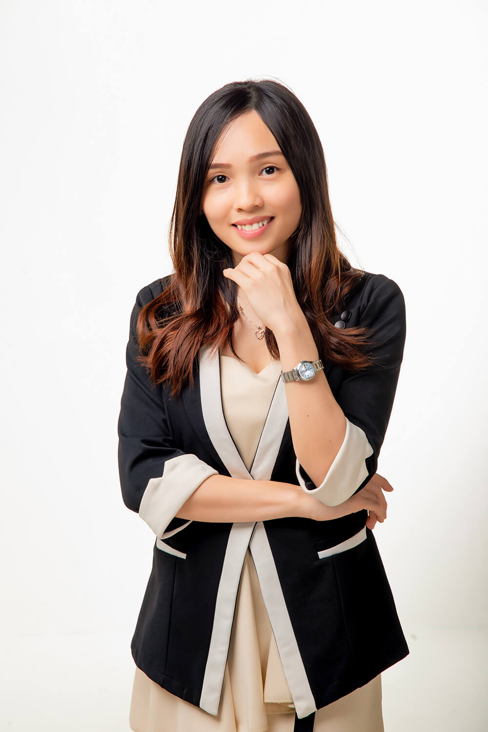 Professional optometrist with a thoughtful expression, wearing a stylish black and white blazer, symbolizing compassionate optical care.